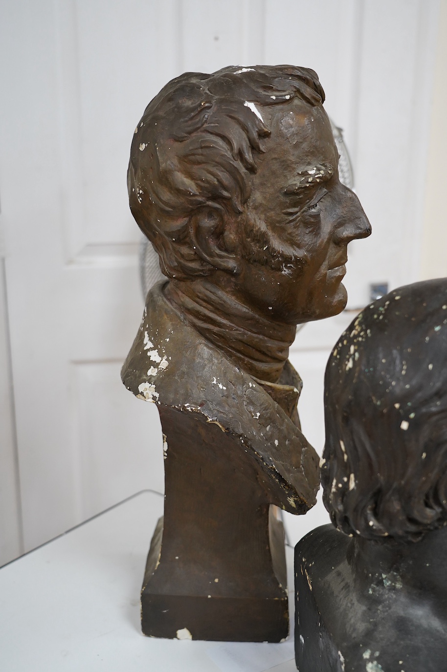 Three decorative plaster busts; the Duke of Wellington, 60cm high, another male figure, and a child. Condition - poor